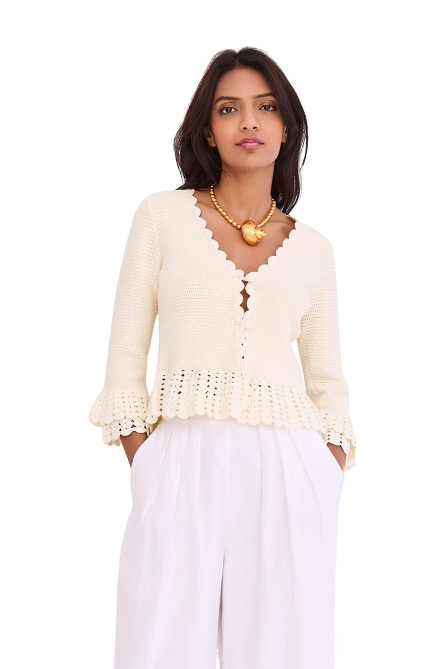 Bunny and Babe Winnetka ivory crochet cardigan with ruffled hem, tiered cuffs, scallop edge neck, and button closure.