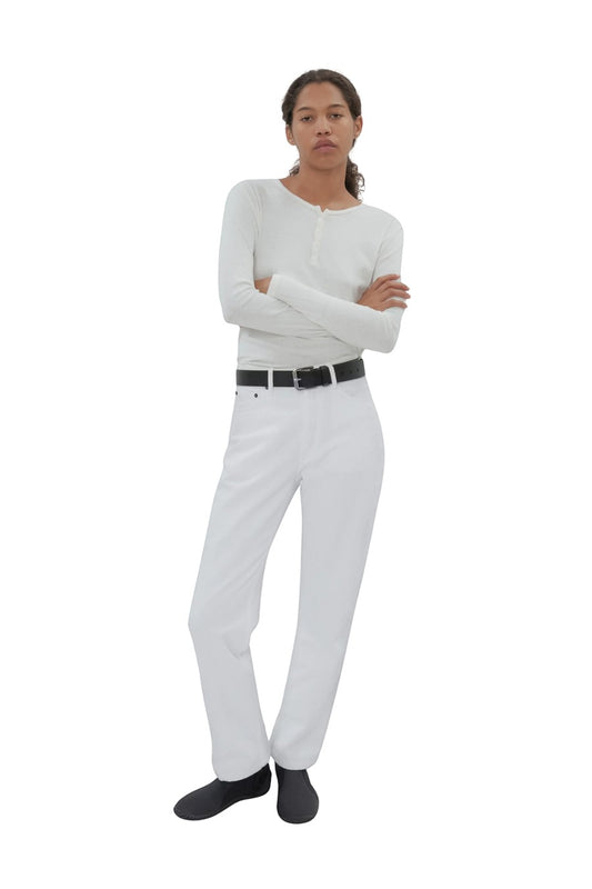 Bunny and Babe Winnetka white 100% cotton high-rise straight-leg jeans with button fly and black belt worn by a woman.